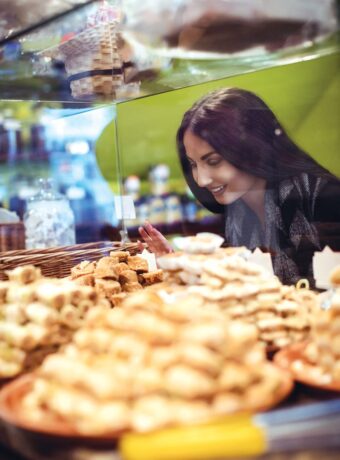woman-looking-turkish-sweets-shop