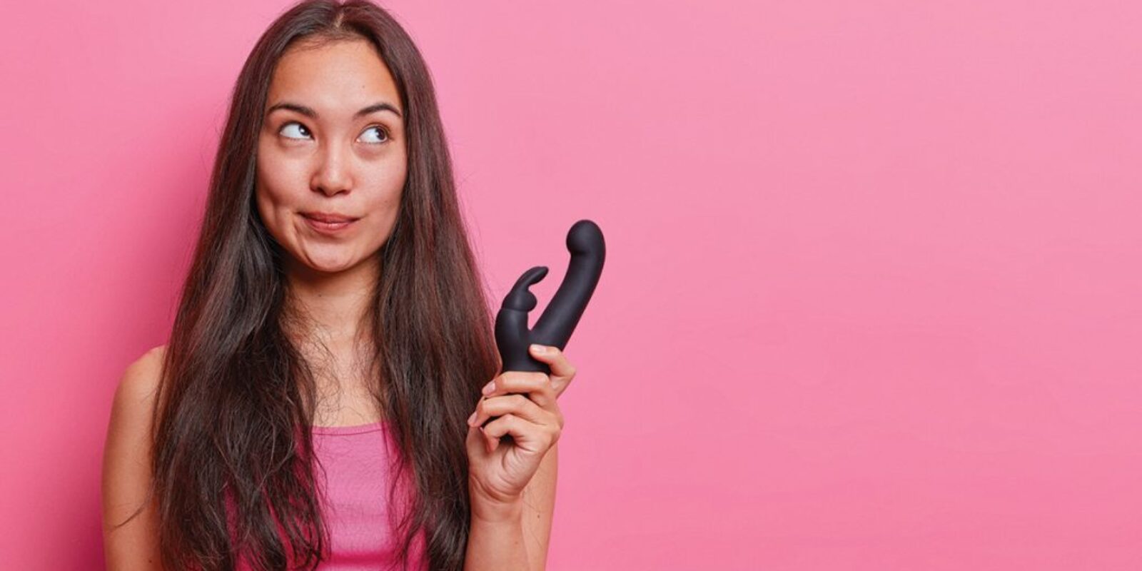 horizontal-shot-thoughtful-asian-woman-holds-rabbit-shaped-vibrator-uses-erotic-toy-pleasuring-buys-vibrating-sex-toys-adults-gets-relaxation-pleasure-vaginal-exercise-machine