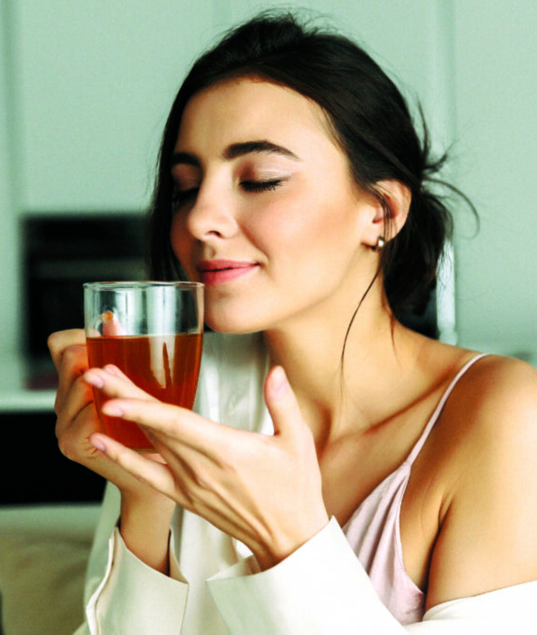 Attractive young woman sitting at the kitchen