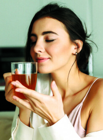 Attractive young woman sitting at the kitchen