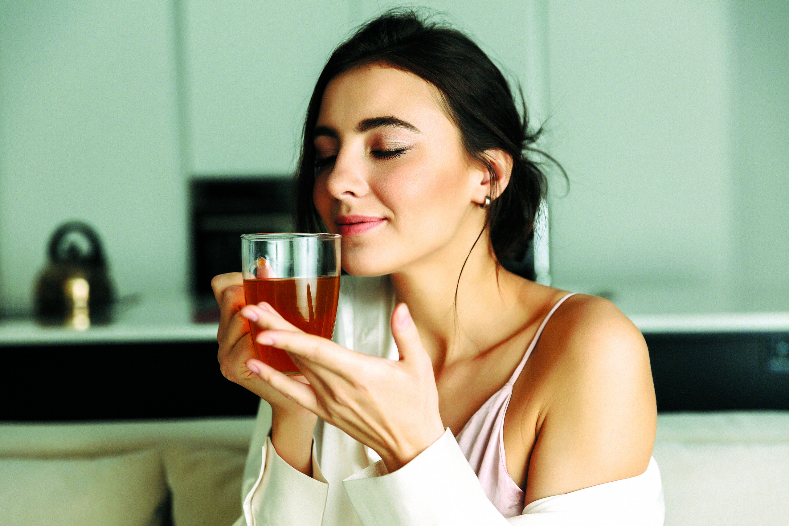 Attractive young woman sitting at the kitchen